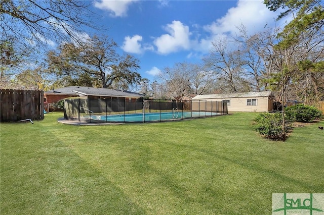 view of yard with a fenced in pool, an outbuilding, and a fenced backyard