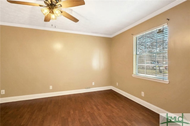 unfurnished room featuring baseboards, a ceiling fan, dark wood finished floors, and crown molding