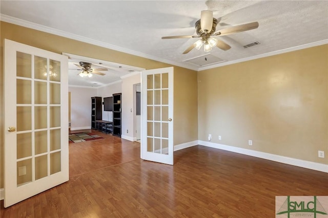 spare room with visible vents, ornamental molding, wood finished floors, french doors, and ceiling fan