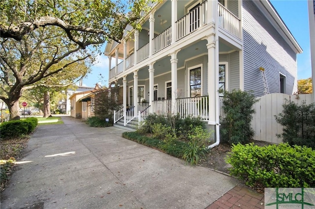 view of side of property featuring covered porch