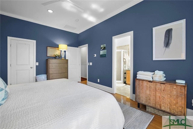 bedroom featuring baseboards and wood finished floors