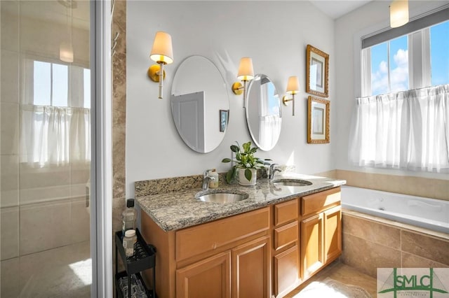 full bath featuring double vanity, tiled shower, a jetted tub, and a sink