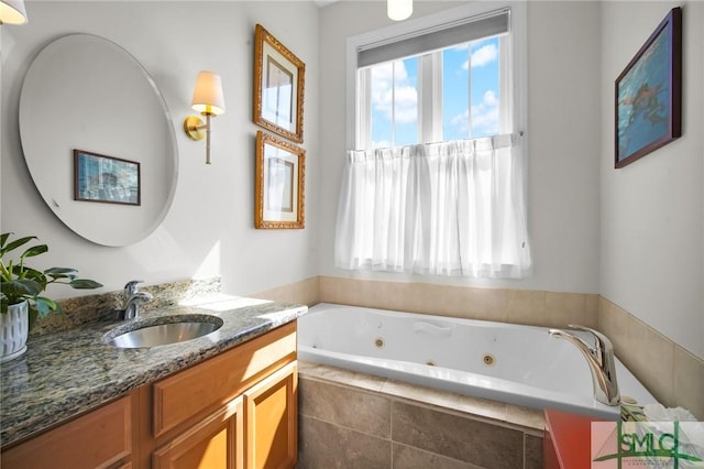 full bathroom featuring a jetted tub and vanity