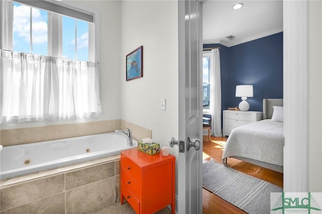 full bath with visible vents, a healthy amount of sunlight, a whirlpool tub, and crown molding