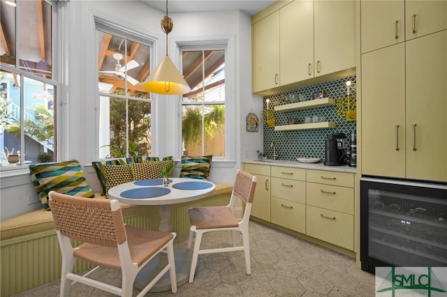 interior space with open shelves, cream cabinetry, beverage cooler, and light countertops