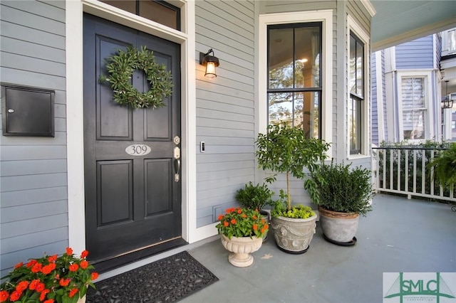 view of exterior entry with a porch