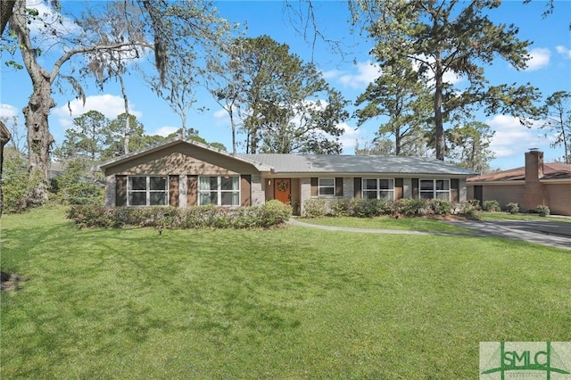 single story home featuring brick siding and a front yard