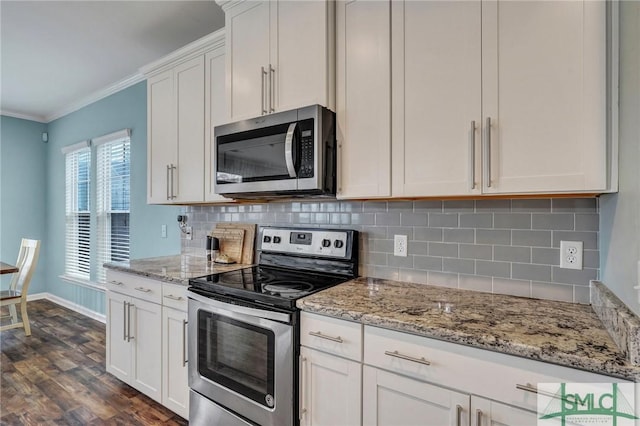 kitchen featuring dark wood-style flooring, white cabinets, stainless steel appliances, and ornamental molding