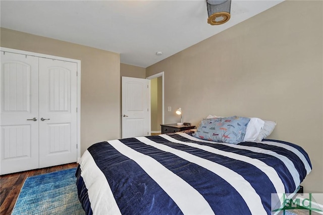 bedroom with wood finished floors and a closet