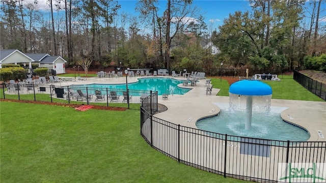 community pool featuring a patio area, a yard, and fence