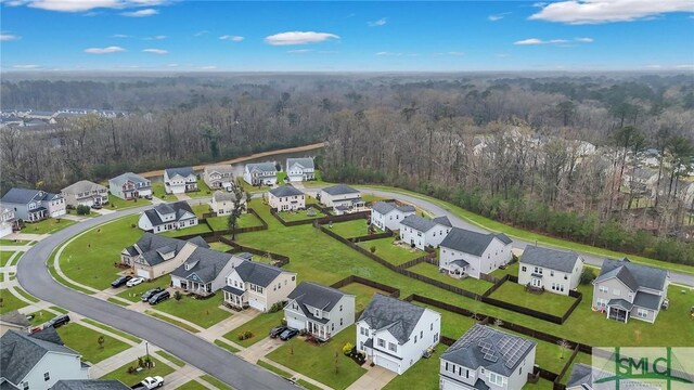 drone / aerial view with a residential view and a wooded view