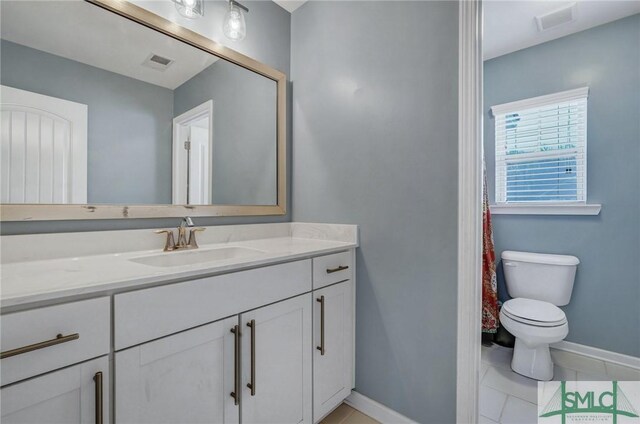 full bathroom featuring visible vents, baseboards, toilet, tile patterned floors, and vanity