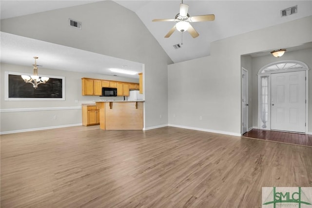 unfurnished living room featuring light wood-style floors, visible vents, and baseboards