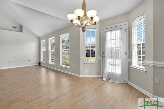 interior space with visible vents, lofted ceiling, light wood-style floors, and baseboards