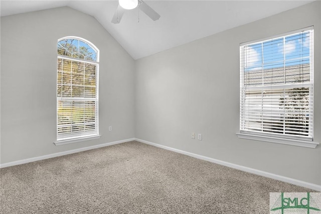 empty room with baseboards, carpet floors, a ceiling fan, and vaulted ceiling