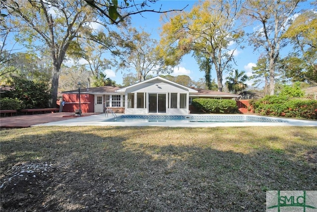 105 Carlton Rd, Savannah, GA 31410 - back of property with a deck, an outdoor pool, a yard, and a sunroom