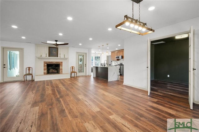 105 Carlton Rd, Savannah, GA 31410 - unfurnished living room featuring recessed lighting, a ceiling fan, dark wood-style floors, and a brick fireplace