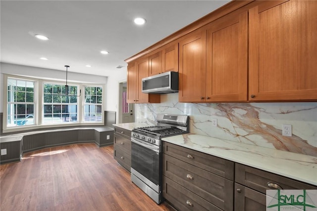 105 Carlton Rd, Savannah, GA 31410 - kitchen featuring appliances with stainless steel finishes, dark wood-style floors, recessed lighting, backsplash, and brown cabinetry