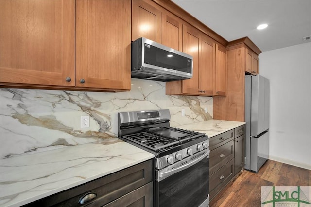 105 Carlton Rd, Savannah, GA 31410 - kitchen featuring stainless steel appliances, dark wood-type flooring, light stone countertops, decorative backsplash, and recessed lighting