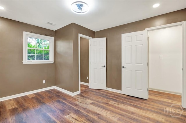 105 Carlton Rd, Savannah, GA 31410 - unfurnished bedroom with wood finished floors and recessed lighting