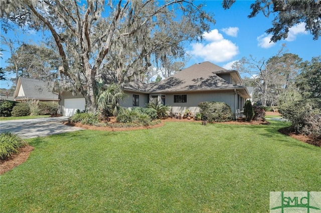 view of front facade with a front lawn, concrete driveway, and an attached garage