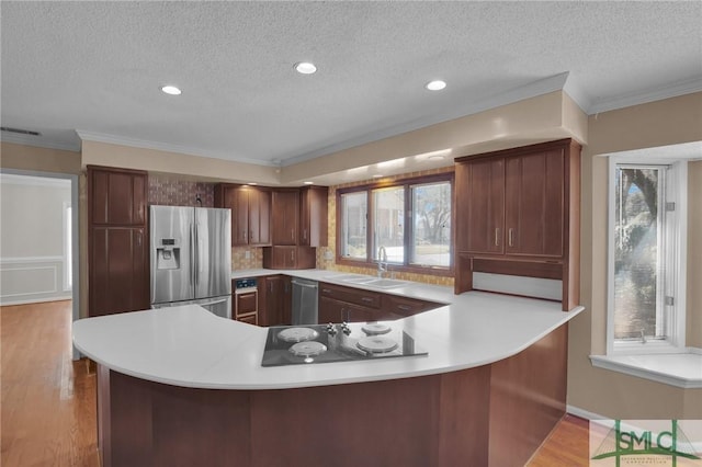 kitchen featuring a sink, light countertops, visible vents, and stainless steel appliances