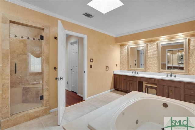 bathroom with visible vents, a skylight, a sink, a shower stall, and crown molding