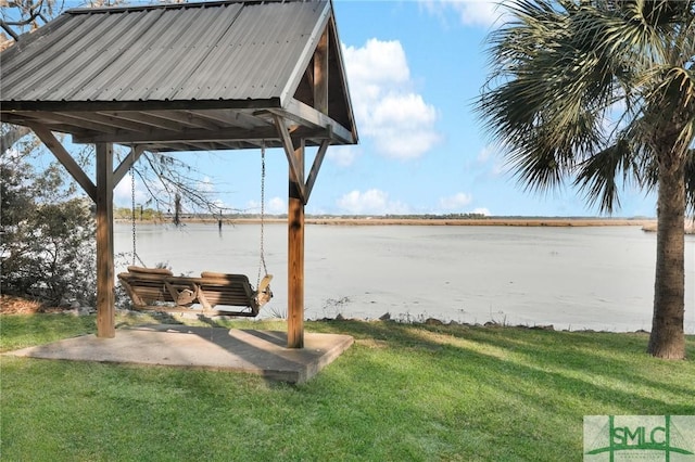 view of yard featuring a water view and a patio