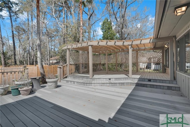 deck with fence and a pergola