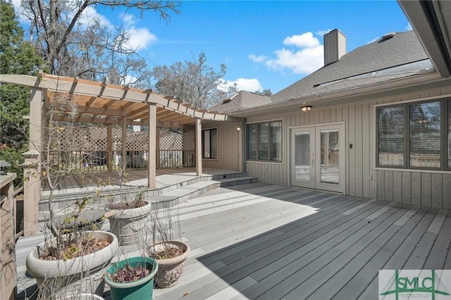 deck featuring french doors and a pergola