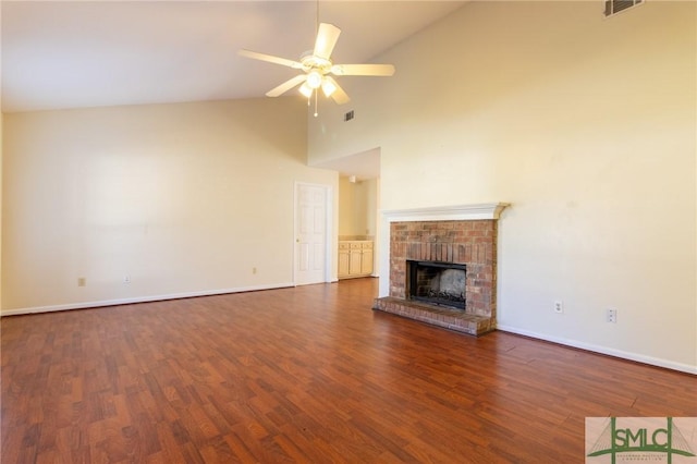 unfurnished living room with baseboards, a fireplace, high vaulted ceiling, a ceiling fan, and dark wood-style flooring