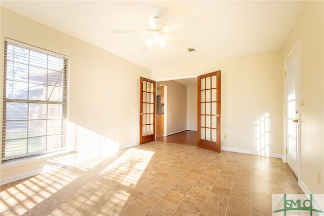 unfurnished room with french doors, baseboards, visible vents, and a ceiling fan