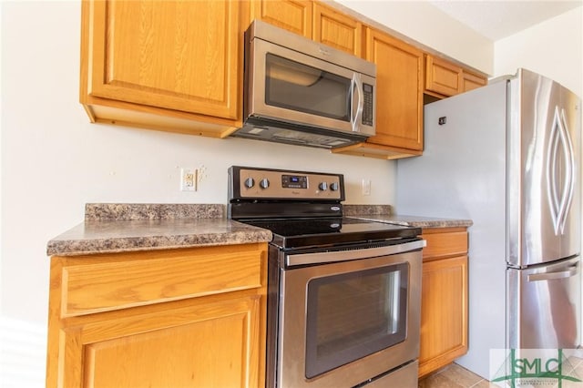 kitchen featuring stainless steel appliances and dark countertops