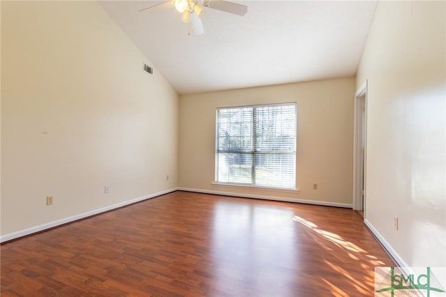 unfurnished room with visible vents, lofted ceiling, wood finished floors, baseboards, and ceiling fan