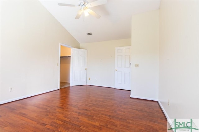 spare room with ceiling fan, visible vents, baseboards, and wood finished floors