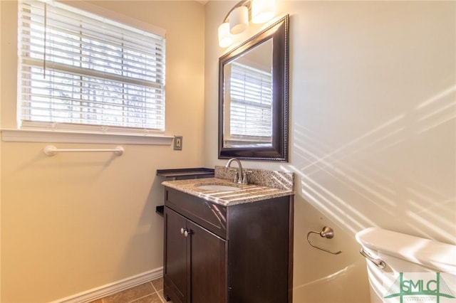 bathroom with vanity, tile patterned floors, and baseboards