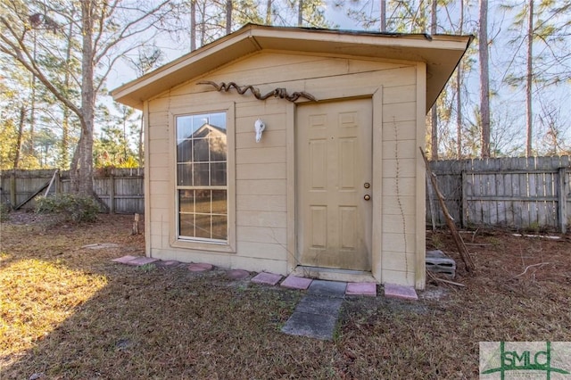 view of shed featuring fence