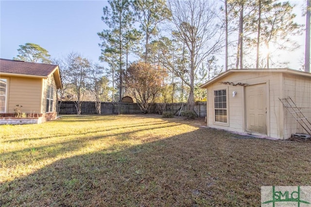 view of yard with an outdoor structure and a fenced backyard