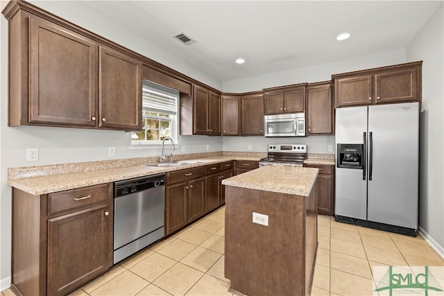 kitchen featuring light tile patterned flooring, visible vents, appliances with stainless steel finishes, and a sink