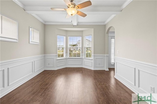 unfurnished room featuring arched walkways, beam ceiling, a ceiling fan, and wood finished floors