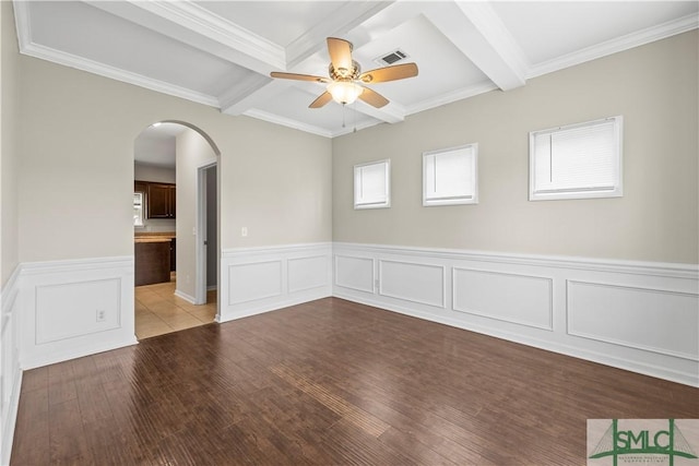 unfurnished room featuring wood finished floors, visible vents, arched walkways, ceiling fan, and beamed ceiling