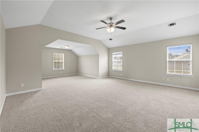 bonus room with plenty of natural light, a ceiling fan, and lofted ceiling