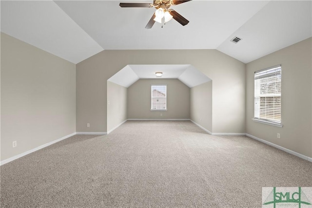 bonus room with vaulted ceiling, a ceiling fan, visible vents, and baseboards