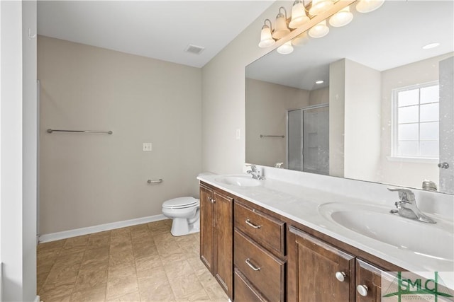 bathroom featuring a shower stall, double vanity, visible vents, and a sink