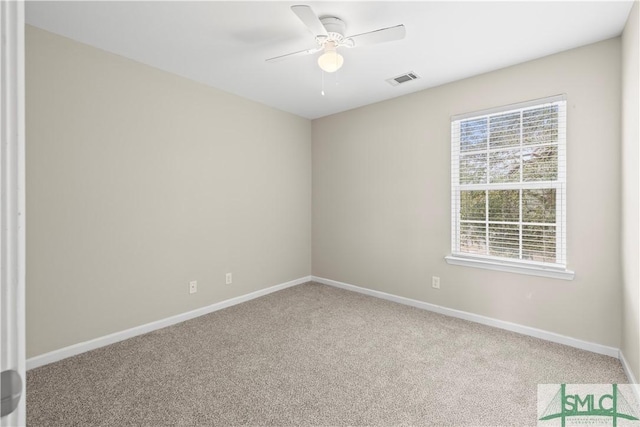 spare room with visible vents, baseboards, carpet, and ceiling fan