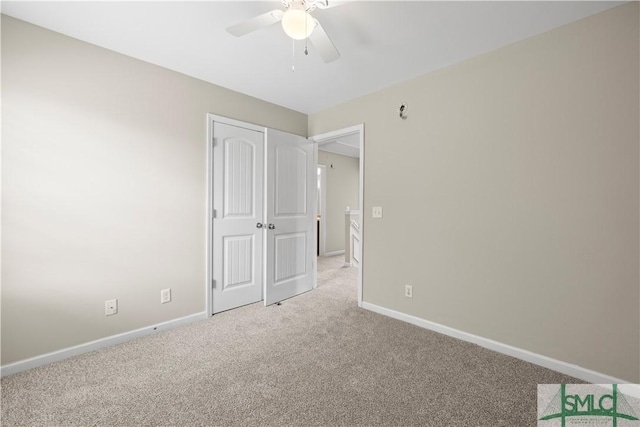 unfurnished bedroom with carpet flooring, a ceiling fan, baseboards, and a closet