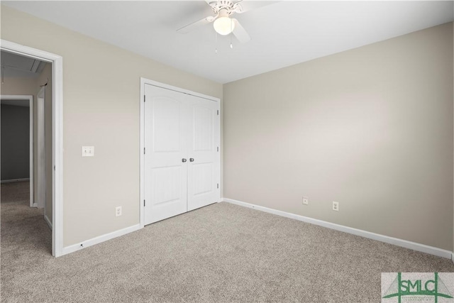 unfurnished bedroom featuring attic access, carpet, baseboards, and a closet