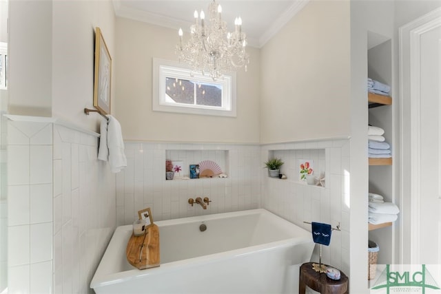 bathroom featuring an inviting chandelier, crown molding, and a freestanding tub