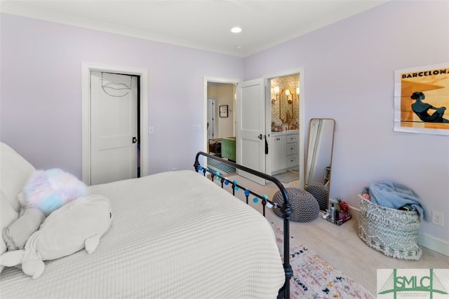 carpeted bedroom featuring ensuite bath, recessed lighting, and baseboards