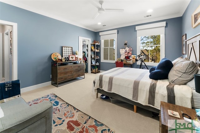 carpeted bedroom with ceiling fan, visible vents, baseboards, and ornamental molding